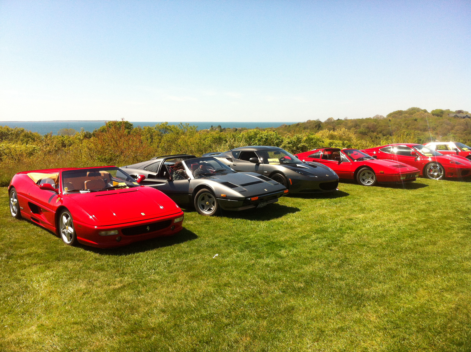 A line up of Ferrari and Lotus sports cars in Montauk Manor car